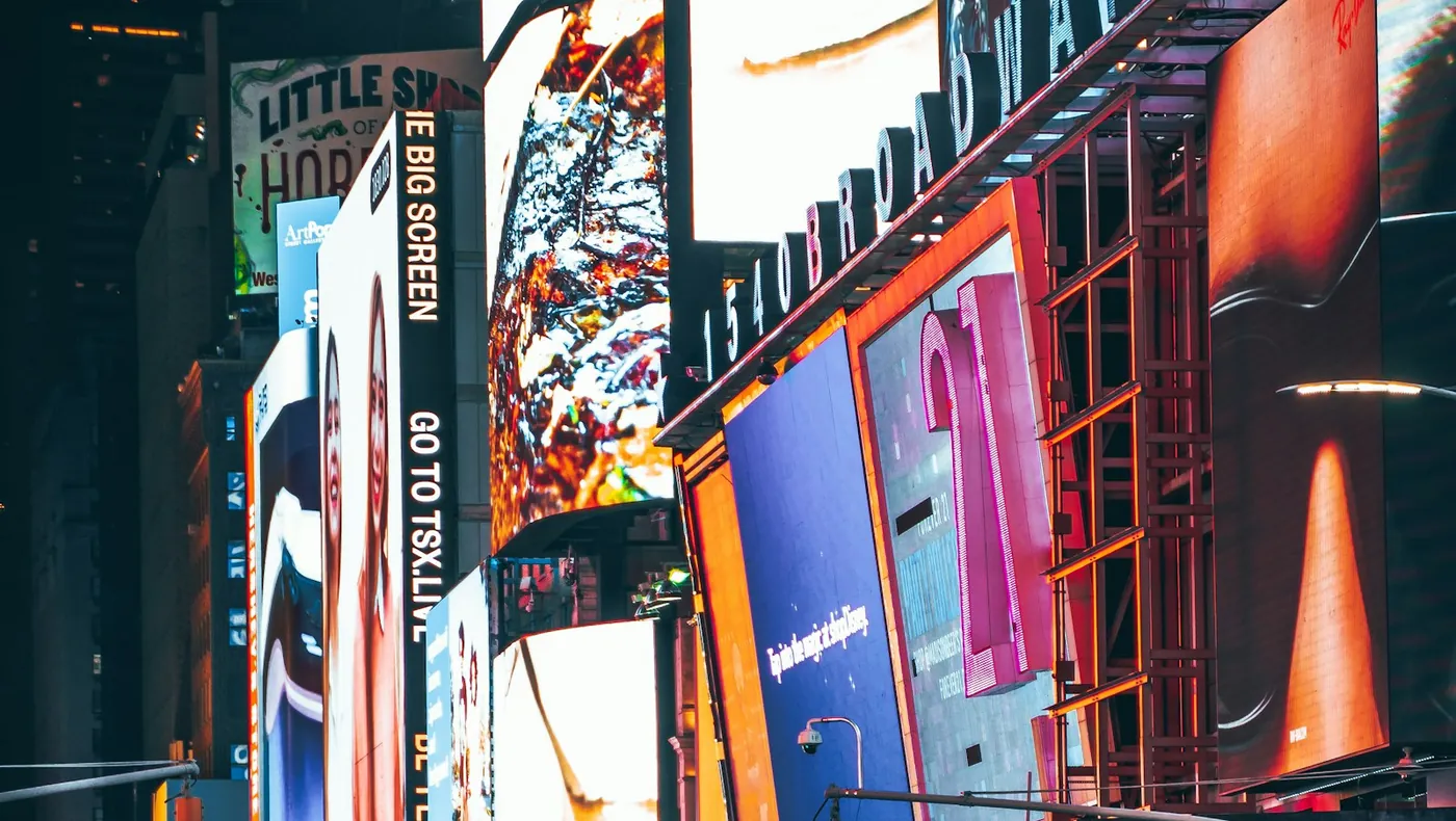 Bright city advertising screens lit up at night
